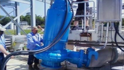 Workers utilizing a Keen Pump Machine sold at Caribbean Basin Enterprises